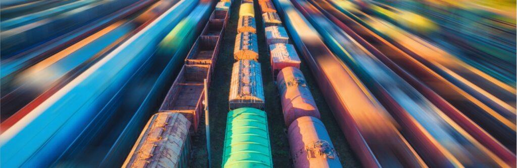 Aerial view of colorful freight trains at sunset.